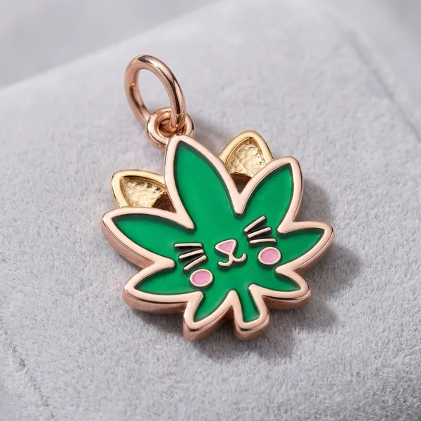 Rose gold leaf charm with a cat face, whiskers, and hammered gold ears
